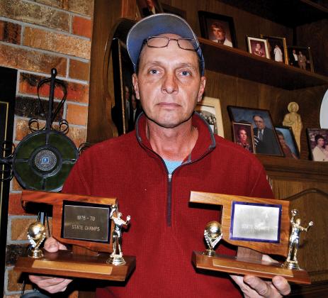 Larry Annuschat shows the trophies that brothers, Ron and Nick brought home in 1979