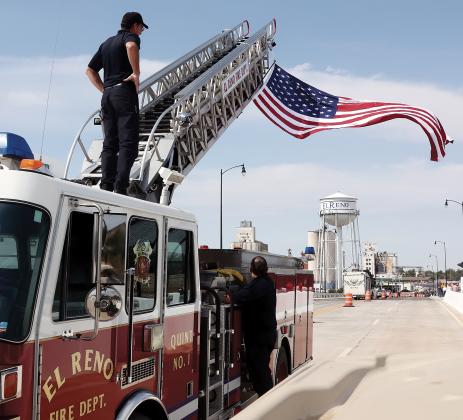 ERFD members use a ladder truck to position the American flag