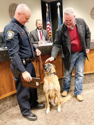 Mayor Steve Jensen pets K-9 Rocco as Sgt. Sandy Dowdle looks on