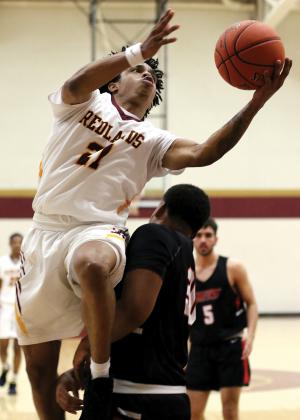 RCC men's basketball_Alexander tries to avoid contact