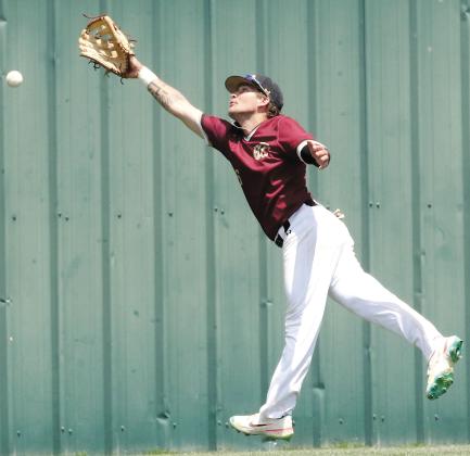 Dustin Whitmire leaps into the air as he tries to snag a fly ball