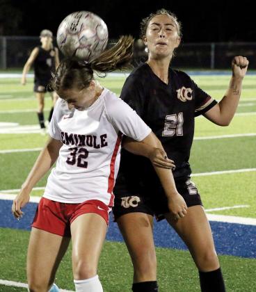 Kylie Thompson locks arms with a Seminole State player