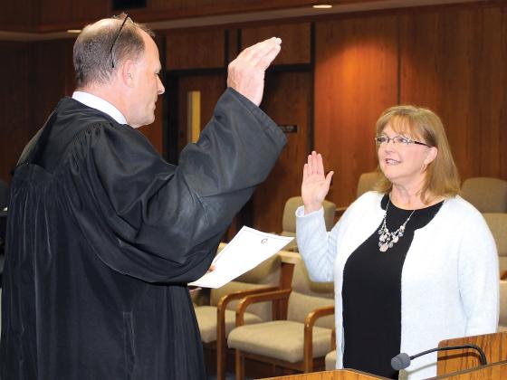 Judge Paul Hesse administers the oath of office to Tracey Rider