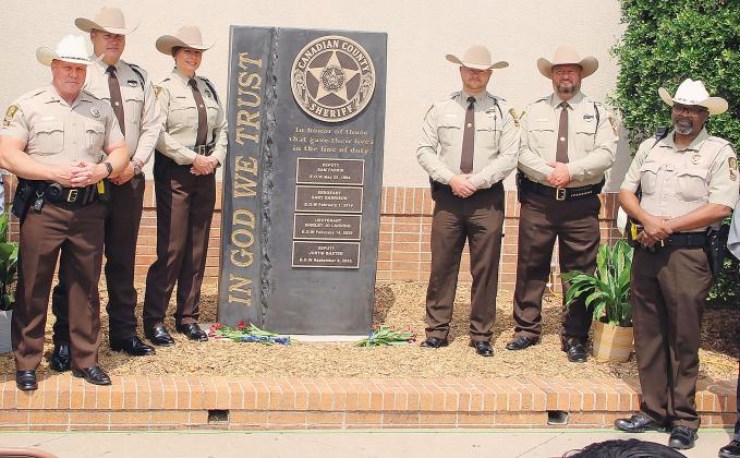 Canadian County Sheriff’s Office personnel stand beside the new Law Enforcement Memorial