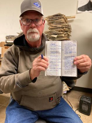 Ray Hosler holds up a notebook