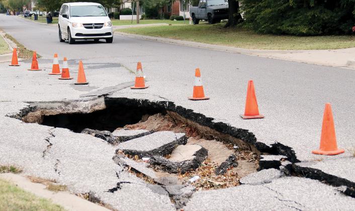 A vehicle approaches the sink hole at Boynton and Shuttee
