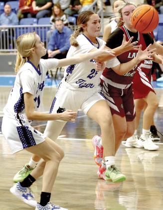 Kamryn Cook tries to grab a rebound as teammate Lily Russell (left) reaches out to help