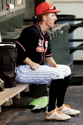 Kyler Thiessen sits quietly in the dugout