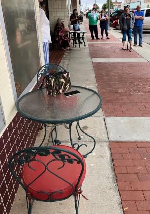 A table and chairs on the sidewalk outside the Centre Theatre