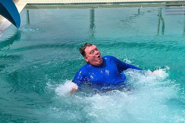 Mayor Matt White slid down one of the slides at the El Reno Municipal Swimming Pool, which reopened after a year's break due to the pandemic.