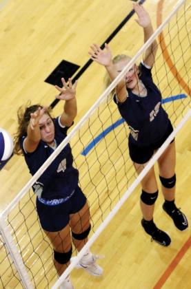 El Reno High School volleyball players Jennis Goucher (4) and Avery Peffer (19) watch the ball sail wide of their double block attempt during the recent El Reno Invitational. Both players had at least one kill in the win over Tuttle.