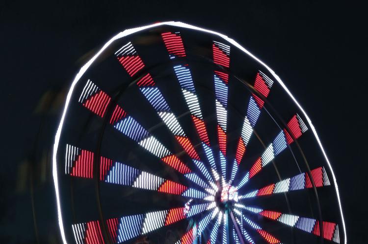The Ferris wheel from Great Plains Amusement lights up the night sky