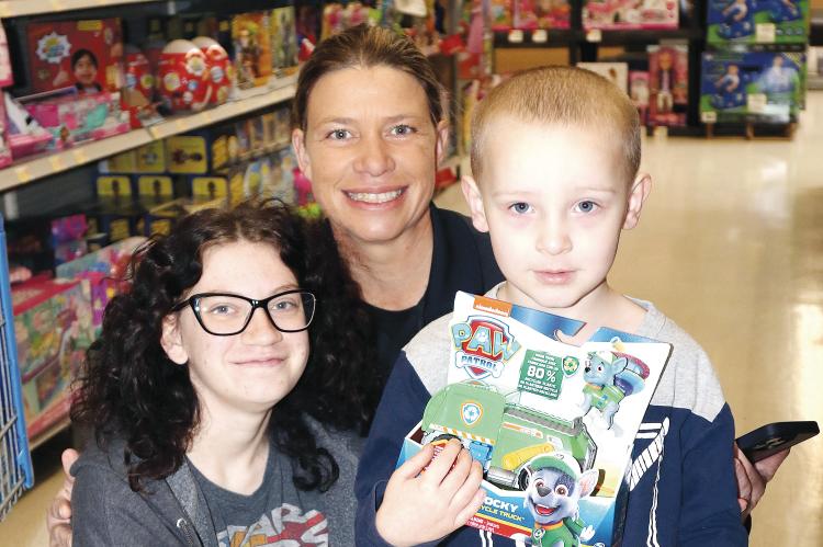 Liz Hodgson poses with her little shoppers, Jessica Parson (left) and Lyric Kaup