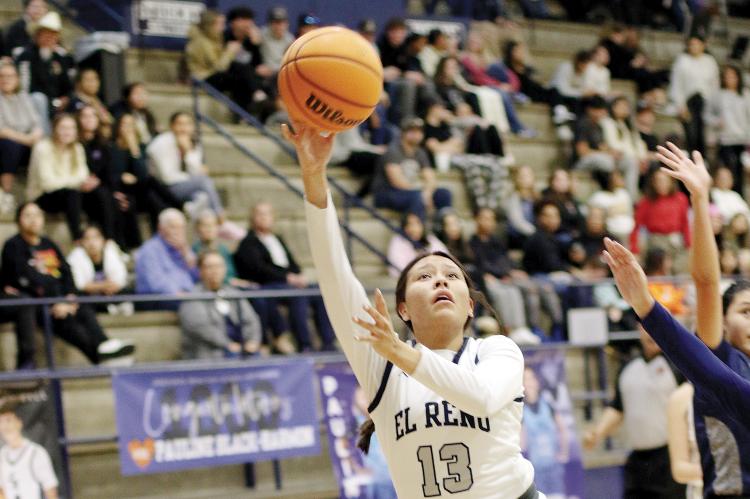 Nazhoni Sleeper eyes the basket as she jumps past Shawnee defenders to shoot a layup
