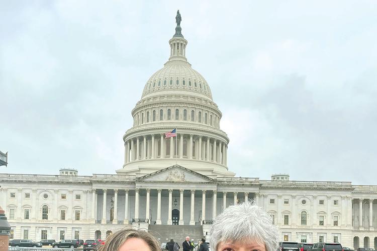 Dorrie Parrott (left) and Suzanne Cannon stand in front of the U.S. Capitol Building