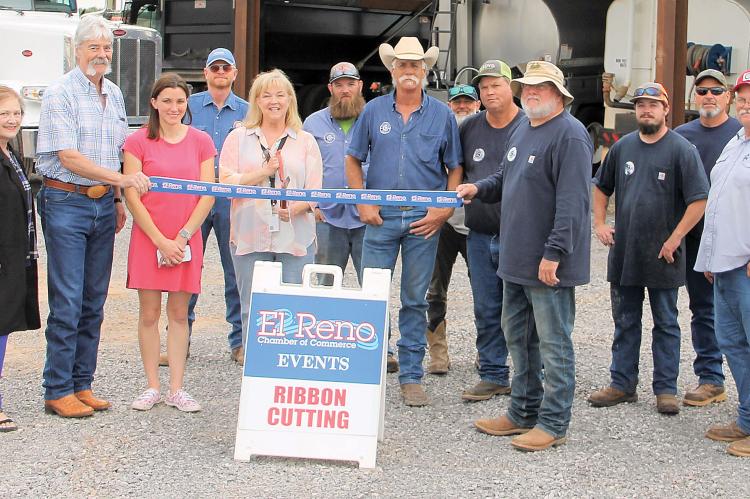 Tracey Rider (holding the oversized scissors) is joined by District 3 foreman Dean Walker and other district personnel 