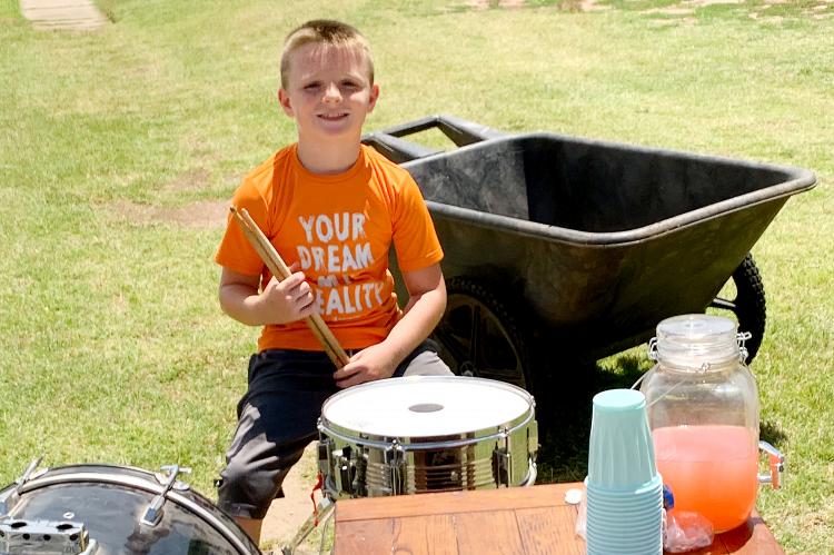 Keegan Miller used his drum skills to draw attention to his lemonade stand