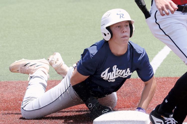 Dawson Davidson looks up for the ball after sliding headfirst into third base