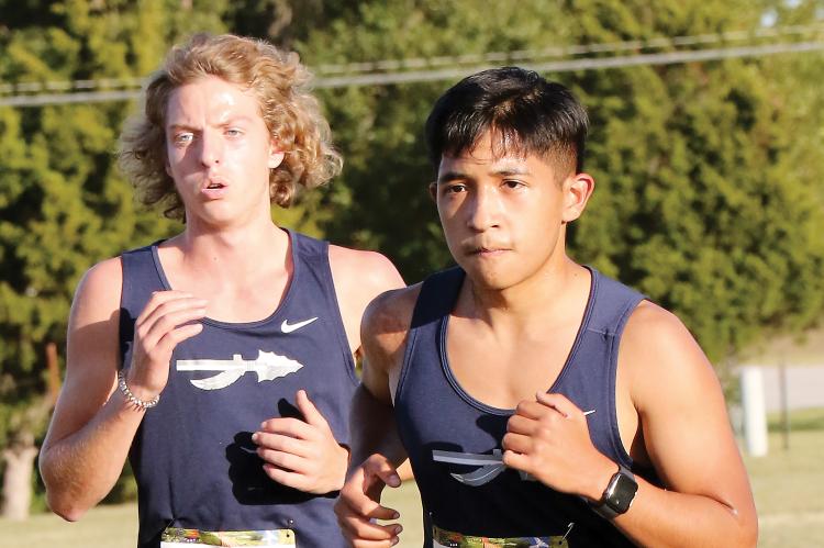 Cole Strong and Erik Vazquez run together at the front section
