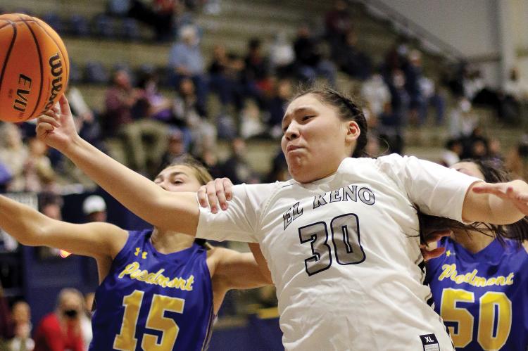 Paige Primeaux has her arm pulled back from a rebound attempt