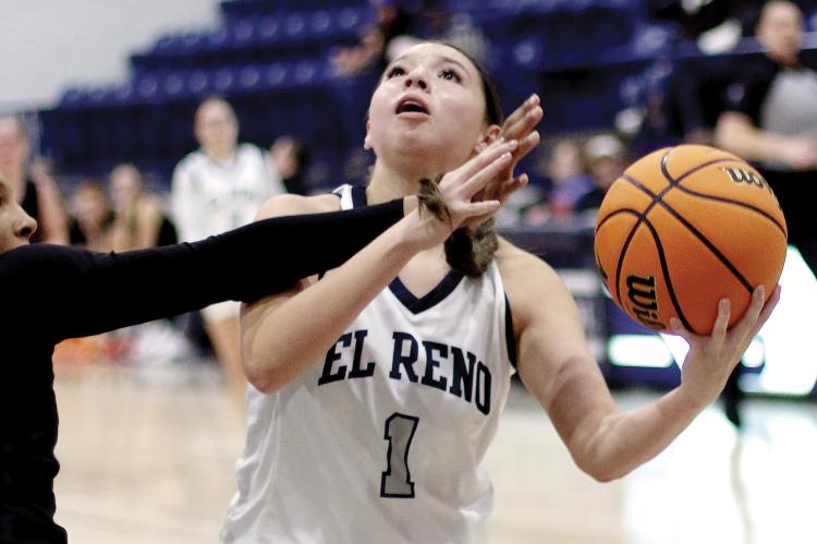Emmary Elizondo eyes the basket while taking a shot under a defender’s arm