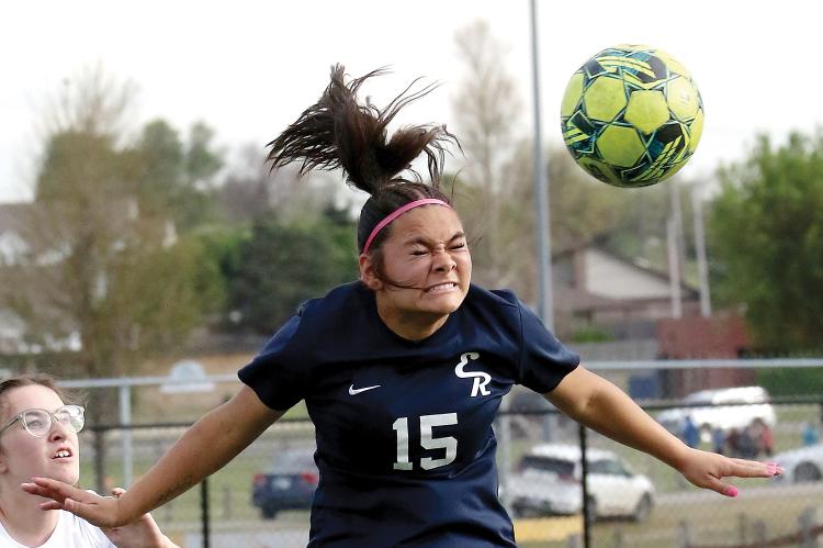 Lily Menjivar uses her head to redirect a throw-in pass