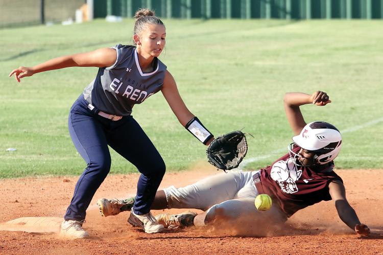 Natalie Gion reaches down to glove a throw to the bag