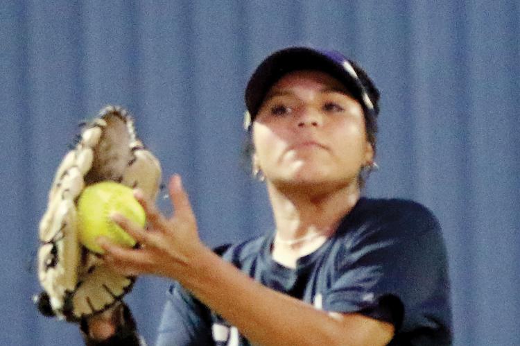 Justine Johnson uses her hand to secure a pop fly in her glove