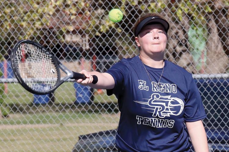Serenity Billings reaches out to hit a forehand return shot