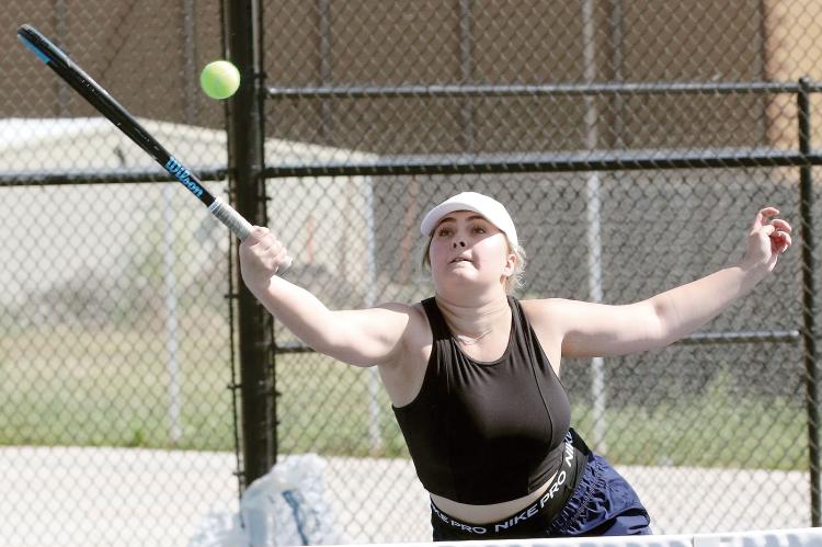 Melanna Idell jumps to reach a forehand return at the net