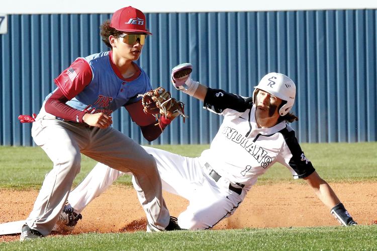 Dacien Ramos slides into second base ahead of a throw to the bag