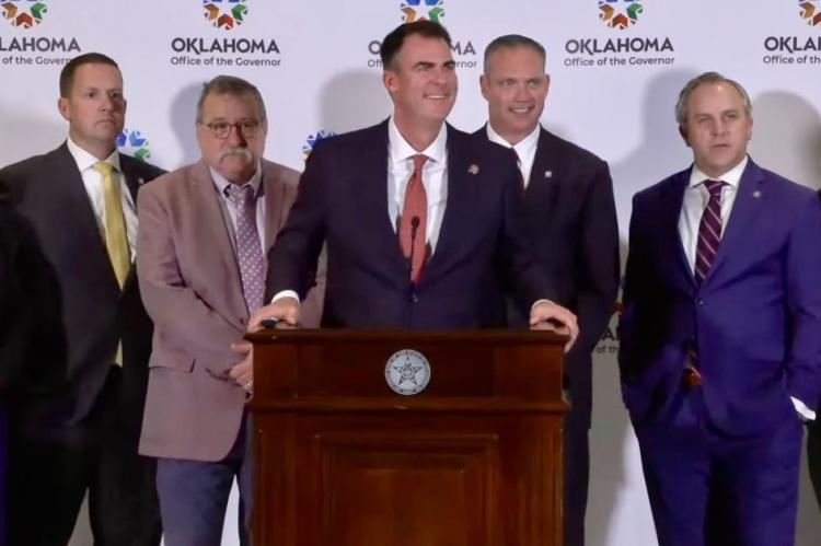 Kevin Stitt (center) answers questions about education funding