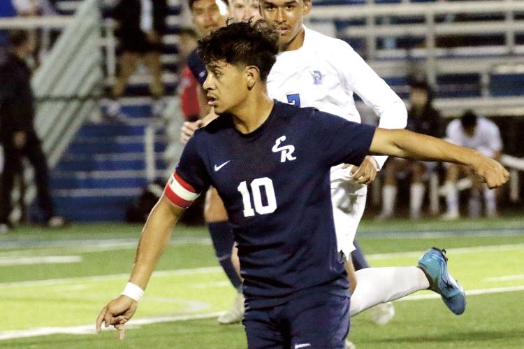 Edgar Perez dribbles the ball away from the pursuit of a Southeast player