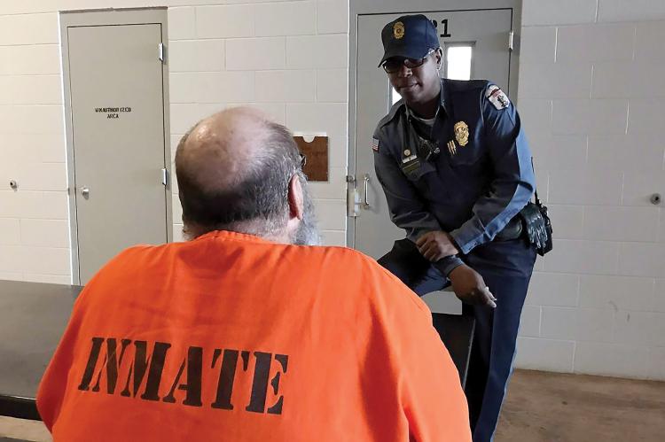 Correction officer talks with inmate