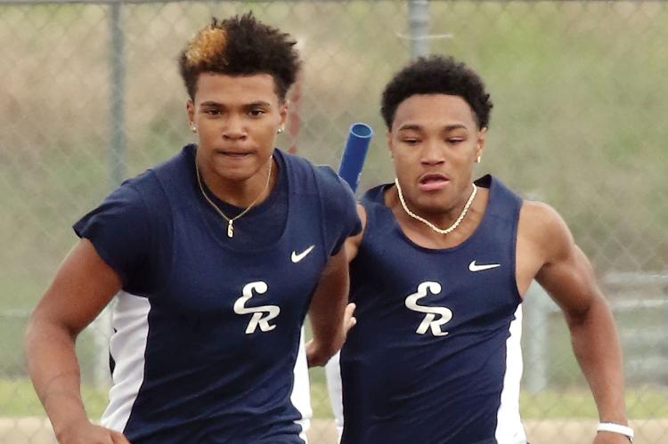 Latin Everheart (right) hands off the baton to Elijah Fisher