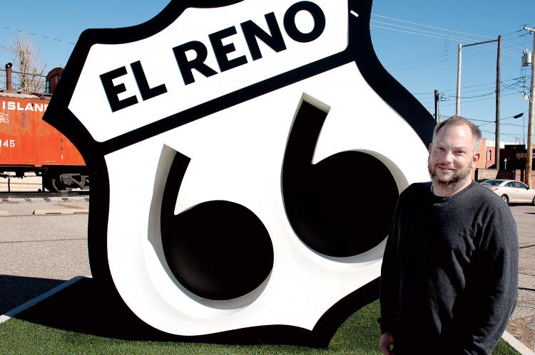 Nolan Stolz stands in front of the Route 66 Monument