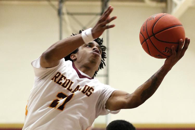 RCC men's basketball_Alexander tries to avoid contact