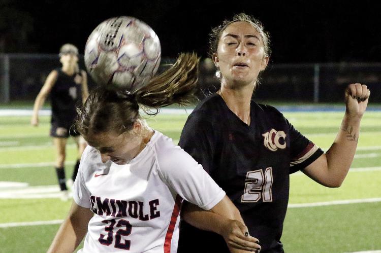 Kylie Thompson locks arms with a Seminole State player