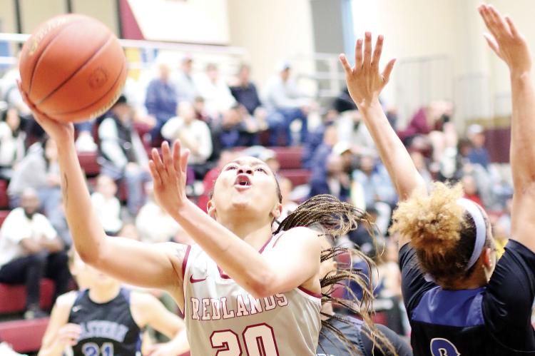 Brooklyn Haywood slices between two Eastern defenders on a shot attempt