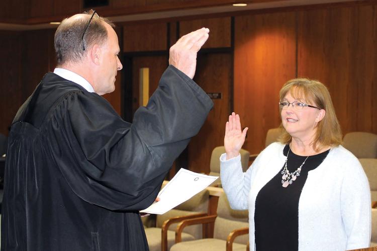 Judge Paul Hesse administers the oath of office to Tracey Rider