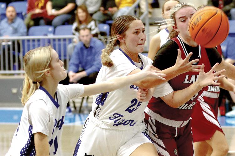 Kamryn Cook tries to grab a rebound as teammate Lily Russell (left) reaches out to help