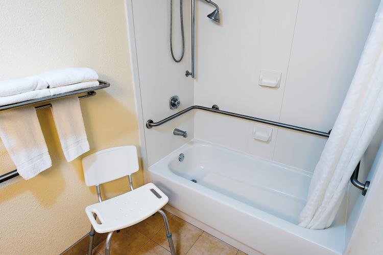 A shower bench and grab bars in the bathroom makes bathing easier