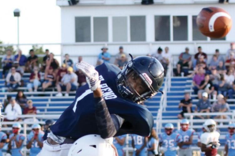 El Reno receiver Gana Nicholson loses control of the football after getting hit in the back by a Clinton defender.