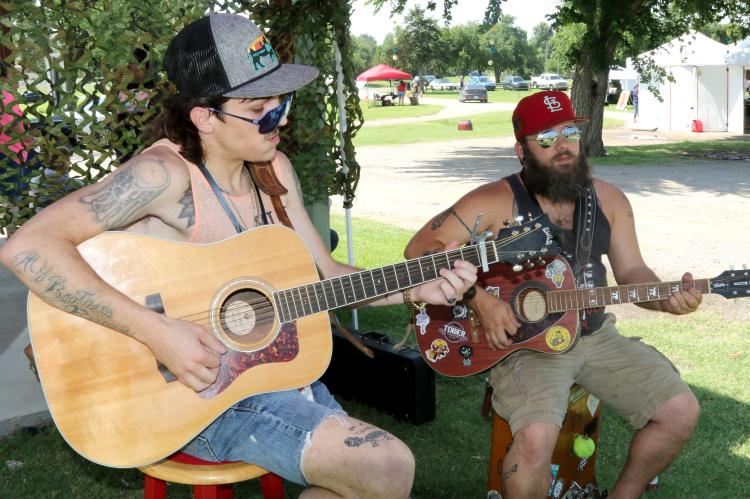 Ethan Ryans (left) and Cody Hassell play their guitars