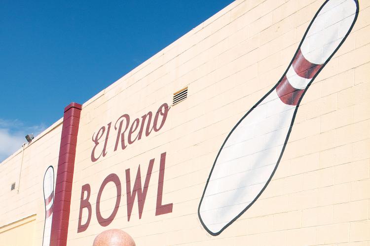 David Dunn and Melissa Stringer in front of the El Reno Bowl sign