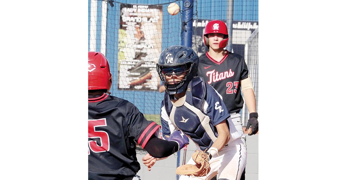 Austin Castanon has the ball bounce high off his glove while turning to tag a Carl Albert runner_slideshow