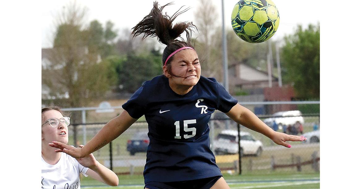 Lily Menjivar uses her head to redirect a throw-in pass_slideshow